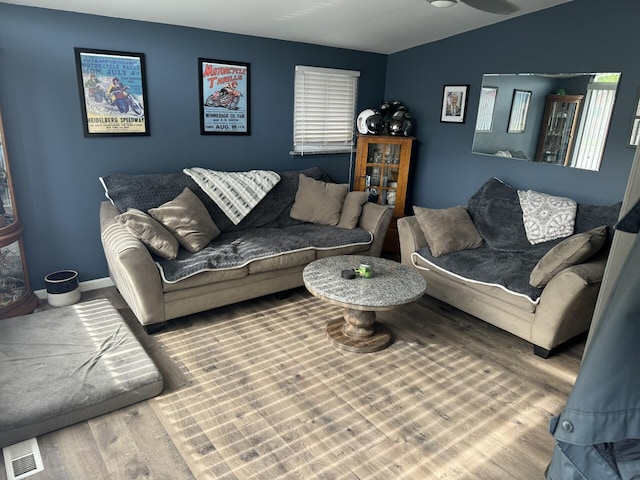 living room featuring hardwood / wood-style floors and vaulted ceiling