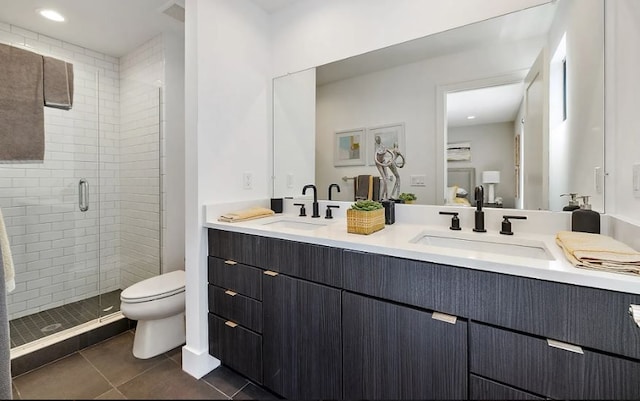 bathroom featuring tile patterned floors, vanity, toilet, and walk in shower