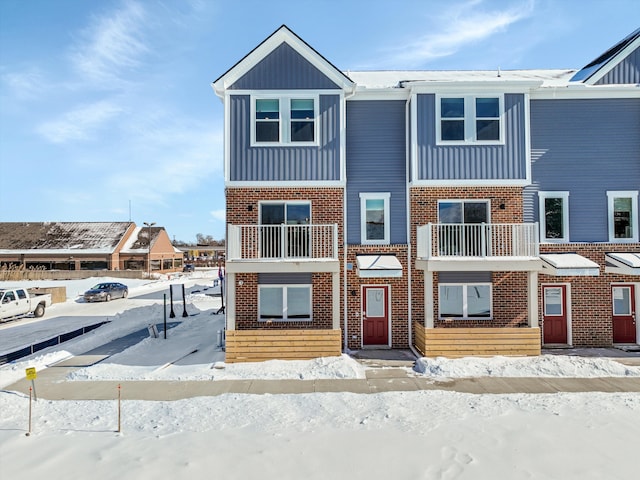 townhome / multi-family property with board and batten siding and brick siding