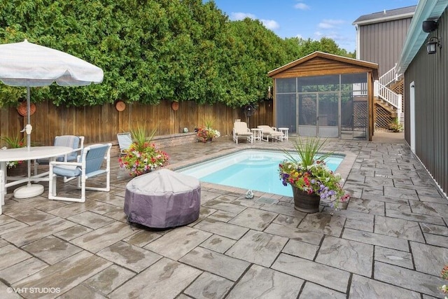 15320 Three Oaks Rd, Three Oaks, MI 49128 - view of pool featuring a sunroom, a patio area, stairs, and a fenced backyard