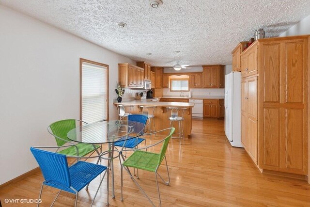 15320 Three Oaks Rd, Three Oaks, MI 49128 - dining room with a textured ceiling and light wood-type flooring