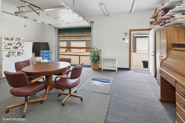 dining area featuring dark colored carpet