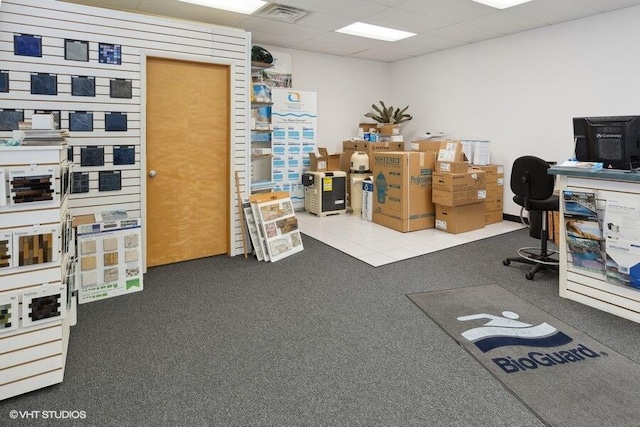 carpeted home office featuring a drop ceiling