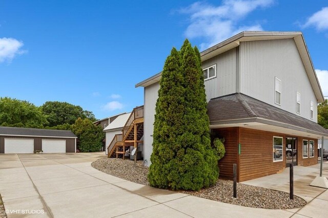 view of home's exterior with a garage and an outdoor structure