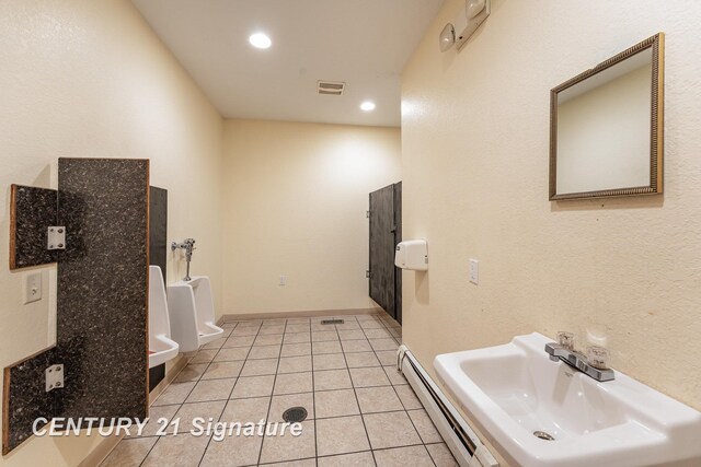 bathroom featuring a baseboard radiator, tile patterned floors, and sink