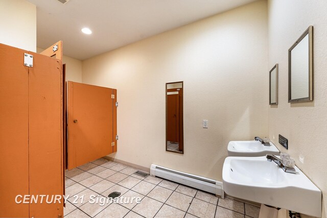 bathroom featuring tile patterned flooring, sink, and a baseboard radiator