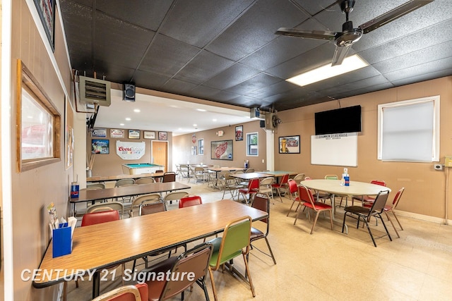 dining space featuring a drop ceiling and ceiling fan