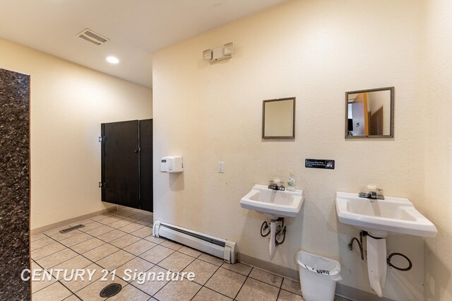 bathroom with tile patterned flooring, sink, and a baseboard radiator