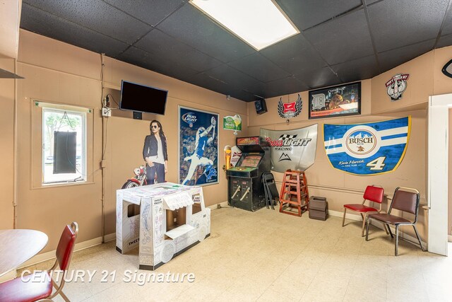 recreation room featuring a drop ceiling