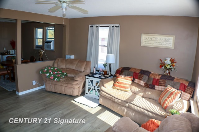 living room with hardwood / wood-style floors, ceiling fan, and cooling unit