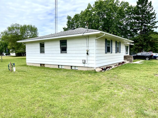 view of side of property with a lawn