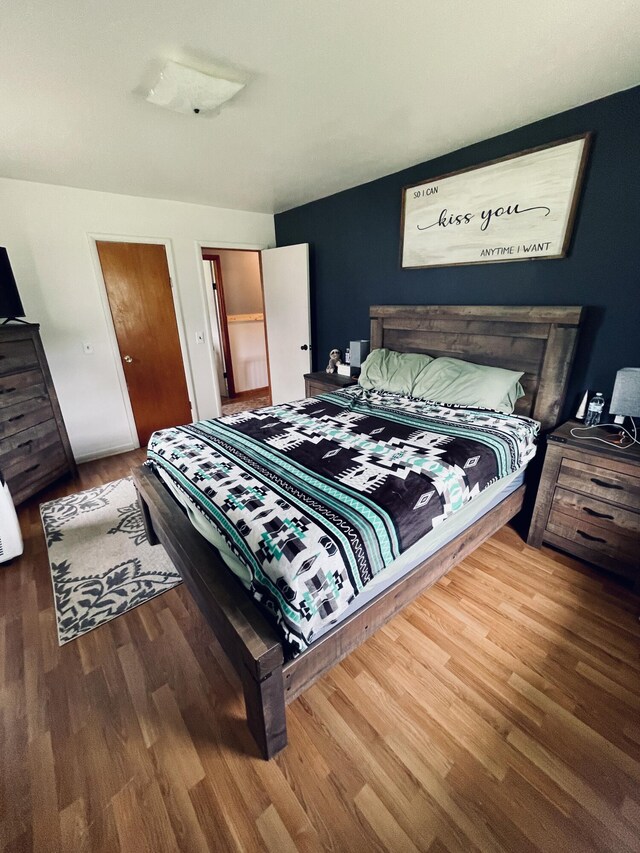 bedroom with hardwood / wood-style floors