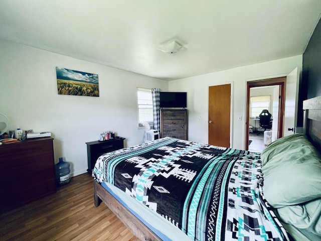 bedroom with dark hardwood / wood-style flooring