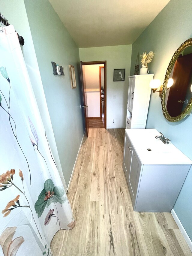 bathroom with wood-type flooring and vanity