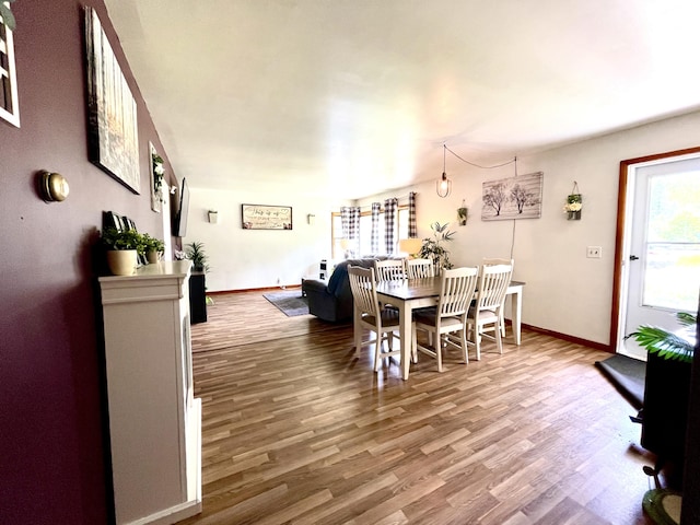 dining area with wood-type flooring and a wealth of natural light