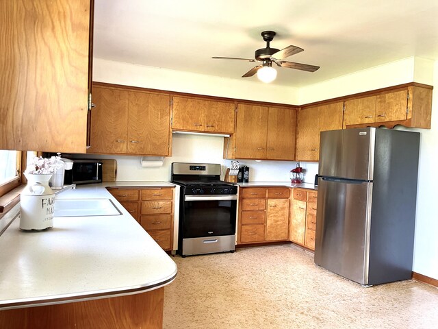 kitchen with sink, ceiling fan, and appliances with stainless steel finishes