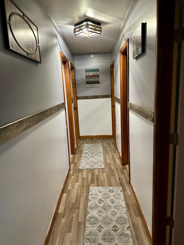 corridor with light hardwood / wood-style flooring