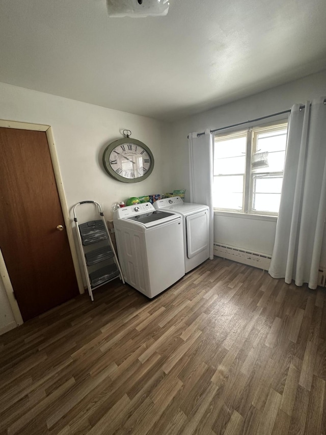 washroom with separate washer and dryer, a baseboard radiator, and dark hardwood / wood-style floors