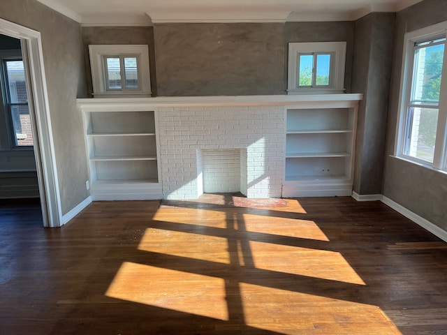 unfurnished living room featuring a fireplace, built in features, and dark wood-type flooring