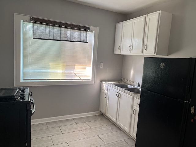 kitchen featuring white cabinetry, sink, and black appliances