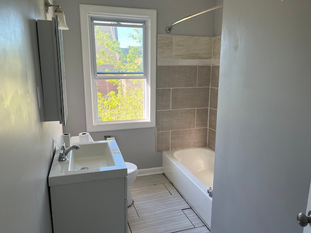 full bathroom with vanity, toilet, and tiled shower / bath