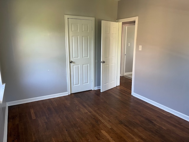 unfurnished bedroom featuring dark hardwood / wood-style floors