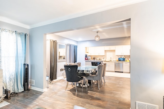 dining room featuring sink and hardwood / wood-style floors