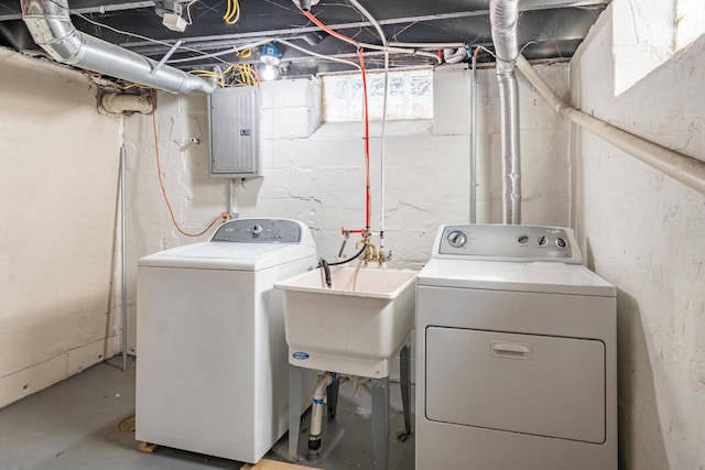 washroom with sink, electric panel, and washing machine and dryer