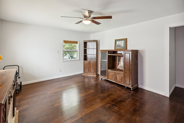 living room featuring ceiling fan and dark wood-type flooring