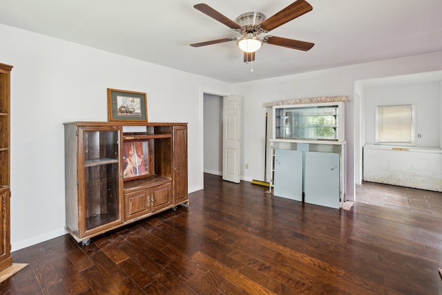 interior space with ceiling fan and dark hardwood / wood-style floors