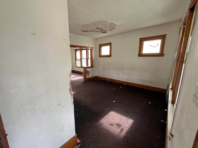 unfurnished room featuring a textured ceiling