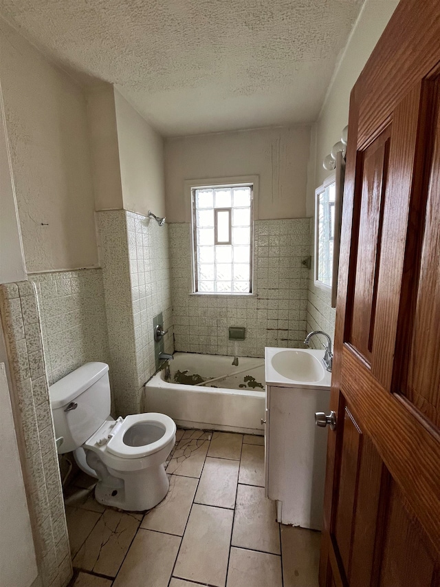 full bathroom with tile patterned flooring, vanity, tile walls, and toilet