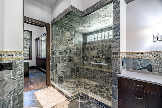 bathroom featuring tile walls and an enclosed shower