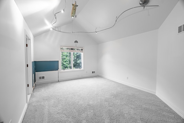 additional living space with carpet floors, vaulted ceiling, and ceiling fan