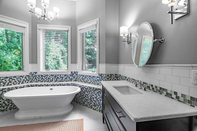 bathroom featuring tile patterned floors, vanity, and a tub