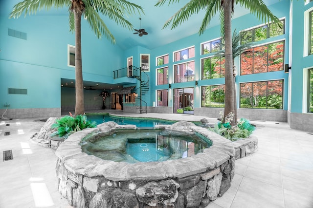 exterior space featuring ceiling fan, a patio area, and an in ground hot tub