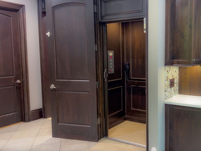 interior space featuring backsplash and elevator