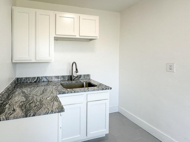 3737 Scovel Pl, Detroit, MI 48208 - kitchen with a sink, white cabinetry, baseboards, and tile patterned floors