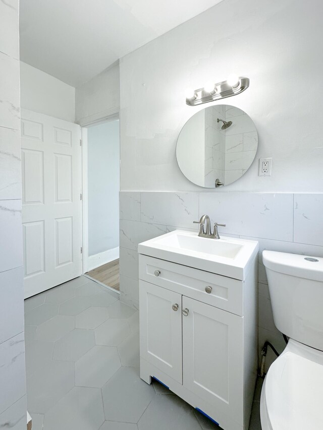 3737 Scovel Pl, Detroit, MI 48208 - bathroom with tile walls, vanity, toilet, and tile patterned flooring