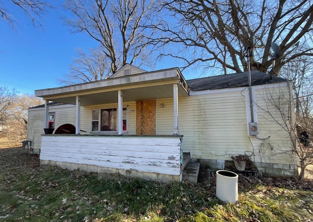 rear view of property featuring a porch