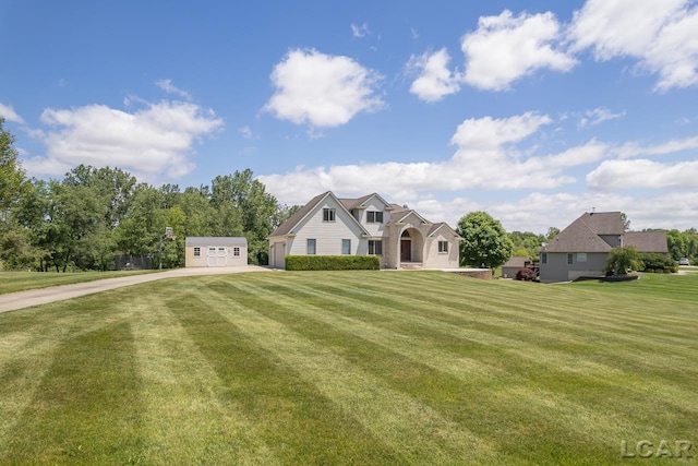 view of front of property featuring an outbuilding and a front yard