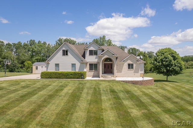 view of front of home with an outdoor structure and a front yard