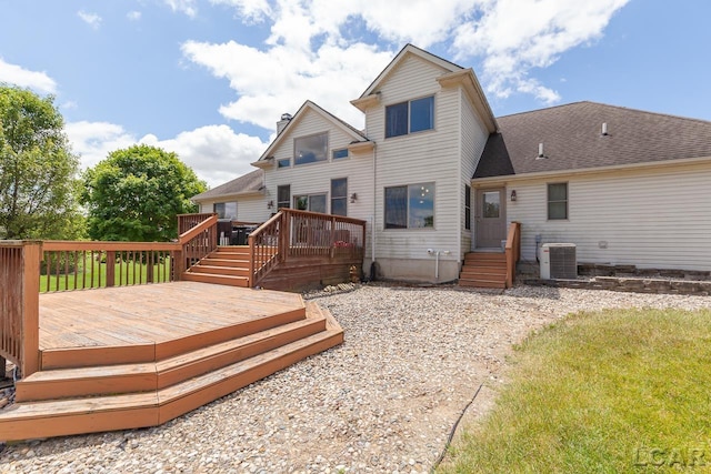 back of house with central AC and a deck