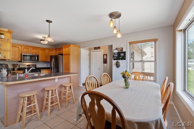 tiled dining room featuring sink