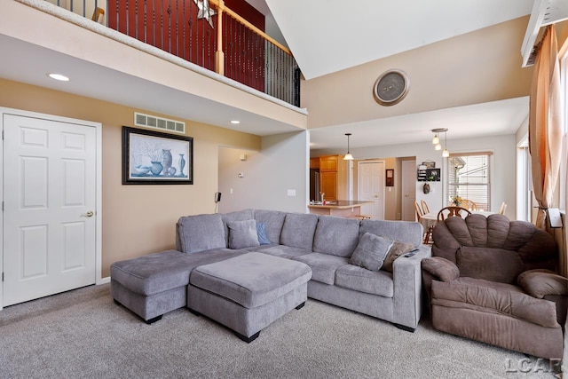 living room featuring carpet floors and high vaulted ceiling