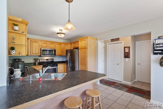 kitchen featuring a kitchen breakfast bar, sink, hanging light fixtures, kitchen peninsula, and stainless steel appliances