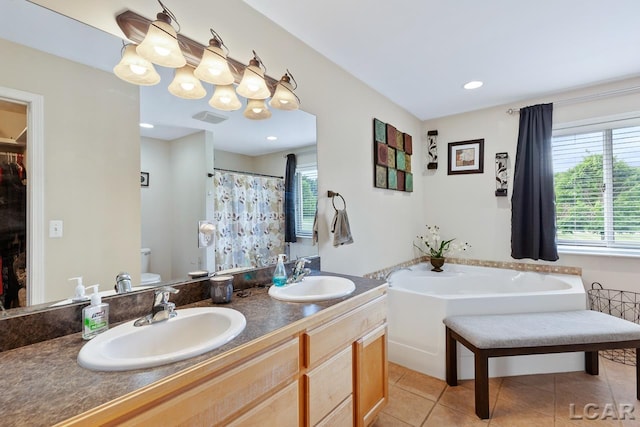 full bathroom with toilet, vanity, tile patterned floors, and separate shower and tub