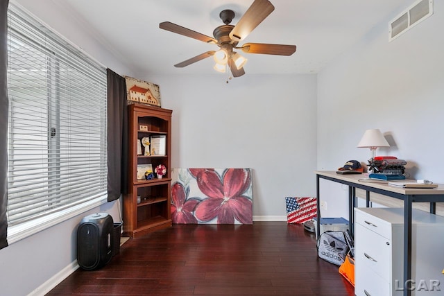 interior space featuring a healthy amount of sunlight, ceiling fan, and dark wood-type flooring