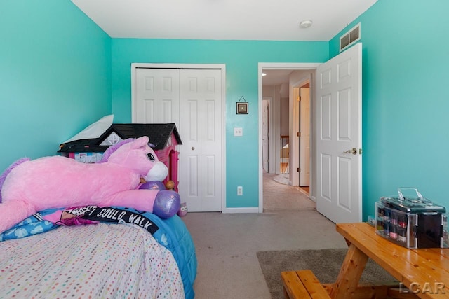 bedroom with light colored carpet and a closet