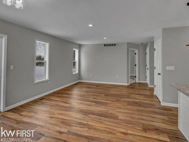 unfurnished living room featuring hardwood / wood-style flooring